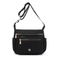 Detailed view of a black multi-pocket crossbody bag featuring elegant gold zippers - Black