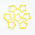 Detailed macro view of seven yellow star-shaped spring lobster clasps for DIY jewelry making - Yellow