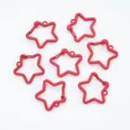 Close-up view of red painted star-shaped lobster clasps for creative DIY jewelry making - Red