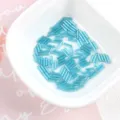 Macro view of blue 2x7mm silver-lined glass bugle beads for DIY jewelry in a white bowl - 20g/Pack / Blue