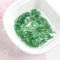 Macro detail of 2x7mm green silver-lined glass bugle beads for handmade jewelry crafts - 20g/Pack / 05# Green
