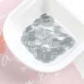 Detailed view of 2x7mm silver-lined glass bugle beads inside a white ceramic dish. - 20g/Pack / 06# Grey
