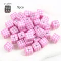 Close-up of pink houndstooth square beads for DIY jewelry and keychain making - Pink Plaid Square Bead