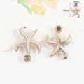 Dettaglio pendente stella Marina bordo dorato, acrilico imitazione madreperla accessorio. - Stella marina (25x18mm) / 1 Pezzo