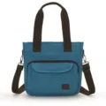 Versatile blue canvas tote bag featuring brown handles and an adjustable shoulder strap - Blue