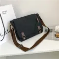 Vintage charcoal grey canvas messenger bag featuring brown adjustable strap - Black