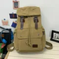 Vintage khaki canvas backpack with drawstring closure and brown leather strap accents - Khaki
