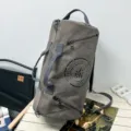 Grey canvas cylinder duffel bag for travel and sports with adjustable shoulder strap - Gray