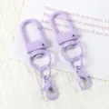 Detailed view of purple baked paint U-shaped swivel keychain hooks and lobster clasps. - 03# Purple