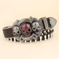 Detailed close-up of a heavy punk style black belt with skull buckle and bullet rivets - 110cm / Black