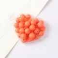 Close-up detail of vibrant orange acrylic round beads in a heart box for DIY craft projects. - Orange 12