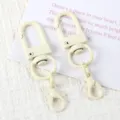 Detailed shot of DIY U-shaped swivel clasp and lobster claw keychain accessories in cream white. - 09# Beige