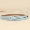Detailed view of light blue leather skinny belt with a stylish silver figure-eight buckle. - 110cm / Light Blue