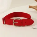Close-up detail of a bright red elastic adjustable belt with a PU leather buckle for sports - 105cm / Red