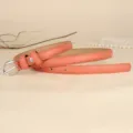 Elegant coral pink slim leather belt for women with polished silver buckle detail - 110cm / Orange Red
