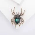 Exquisite close-up of a vintage gold spider brooch featuring a large emerald green gemstone - Emerald Green (SMT1005008590129282)