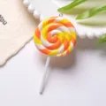Macro view of a large yellow and orange swirl clay lollipop pendant for DIY keychain crafts - With Eye Pin Hook / Orange