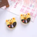 Close-up of cute bear-shaped donut charms with knitted texture and purple bow detail. - Yellow Bear Style