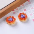 Macro view of miniature resin fruit tarts with purple berries and glossy finish. - Grape Egg Tart