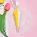 Detail view of 100g dual-color yellow and white decoden cream glue in piping bag - 100g Bag (With 2 Nozzles) / White and Yellow