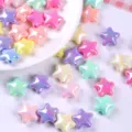 Close-up of colorful iridescent AB-plated star-shaped acrylic beads for DIY jewelry crafts - Star