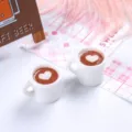 Detailed macro view of two miniature white resin coffee mugs featuring heart-shaped latte art - 白杯加爱心 / 2 Pcs/Set / White