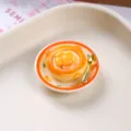 Macro view showing realistic textures of a miniature resin egg tart dessert fridge magnet - Mango Egg Tart Round Bowl