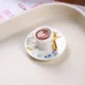 Close-up of miniature coffee cup with latte art heart and floral saucer detail - Layered Heart Coffee Cup and Plate