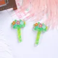 Detailed view of translucent green resin magic wand charms with colorful flowers for DIY. - Green Floral Magic Wand