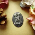 Close-up of a resin relief cabochon featuring conjoined skeleton figures for jewelry making - Connected Souls Style (11)