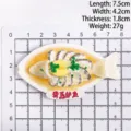 Vista detallada del imán de nevera de pescado con escala de medida y dimensiones - Lubina al Vapor