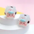 Two cute luminous jelly-textured cartoon sheep animal figurines on a white display stand - M / Patterned White Cow
