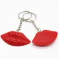 Close-up detail of two red resin lip keychains showing glossy and textured surface finishes - Keychain / Red