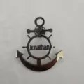 Detail view of a stainless steel anchor brooch with custom Jonathan name engraving. - Anchor Shape / Steel