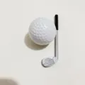 Detailed macro shot of mini white golf ball and silver golf club accessory - 3.2cm / Golf