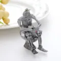 Close-up detail of a unique skeleton sitting on a toilet keychain for Halloween decor. - Light Color Toilet Ghost / Light Gray