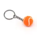 Detail van een oranje tennisbal sleutelhanger van 2 cm met zilverkleurige metalen ring. - 2cm / Oranje