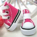 Close-up detail of mini 3.5cm pink canvas sneakers for dolls and keychain accessories - Rose Red