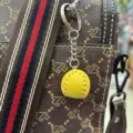 Mini yellow leather baseball keychain 2cm sports pendant hanging on a brown handbag - 2cm / Dark Yellow