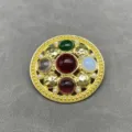 Detailed view of a vintage round metal brooch with colorful gems and hammered texture - Round Hammered Style