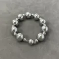 Close-up of metallic silver beaded necklace with magnetic clasp on grey background. - Bracelet B / Silver