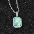 Close-up detail of a silver rope chain necklace with a vibrant fluorescent zircon pendant. - Lake Blue