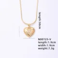 Gold heart pendant necklace detail featuring a crystal letter V and delicate snake chain. - Letter V