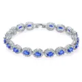 Detailed view of elegant silver bracelet with oval blue zircons and halo diamond setting - Oval Blue Zirconia (KSB00053) / White Gold