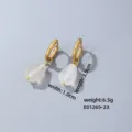 Gold hoop earrings detail view featuring elegant translucent teardrop pendants for refined style. - Clear