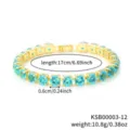 Detailed view of the gold plated tennis bracelet featuring vibrant blue round cut zirconia stones. - Gold Aquamarine Rhinestone