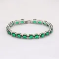 Elegantes silbernes Tennisarmband mit funkelnden ovalen grünen Zirkonia-Steinen - 19cm / Silber Grün Strass