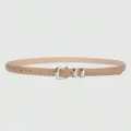 Close up detail of minimalist women thin beige belt featuring polished silver metal buckle. - Beige