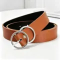 Close up detailed view of women brown PU leather belt featuring silver double ring metal buckle. - Brown Silver Clasp