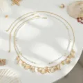 Close-up details of Bohemian multi-layer waist chain with seashells and pearls for beach. - Gold